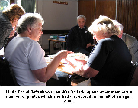 Linda Brand (left) shows Jennifer Ball (right) and other members a number of photos which she had discovered in the loft of an aged aunt.