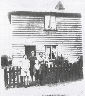 Sarah Ellen Sewell, nee Gall, is standing outside her home at number 4 Waterloo Cottages, Roman Road, Mountnessing, Essex in about 1933